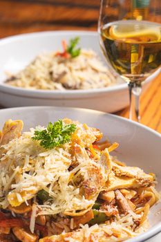 Savor the taste of Italian pasta with a glass of white wine, perfect for gourmet experiences.